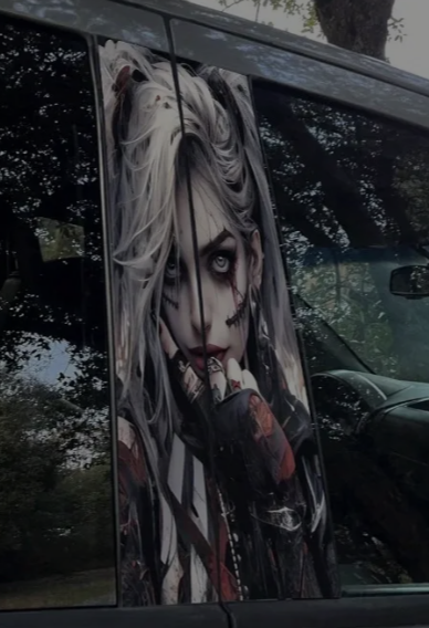Gothic woman with long white hair and dark makeup on vehicle side panel.