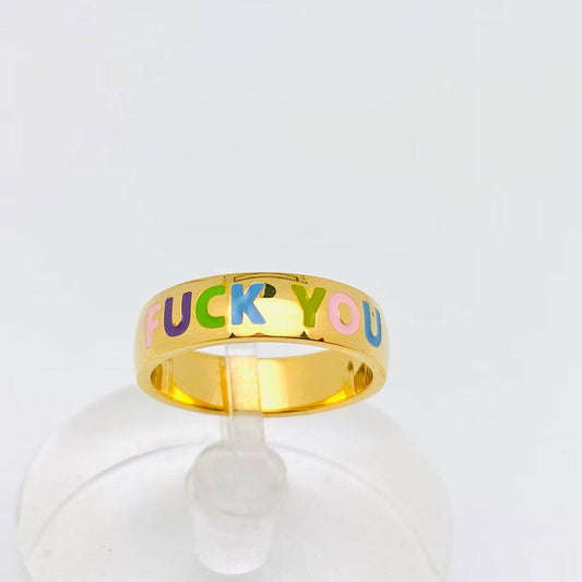 Gold ring with colorful FUCK YOU text on a clear stand.