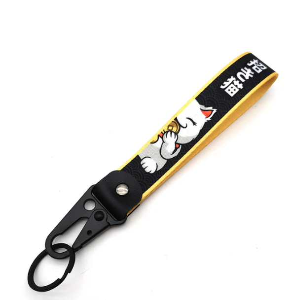 Lucky cat keychain with gold coin design and black strap.