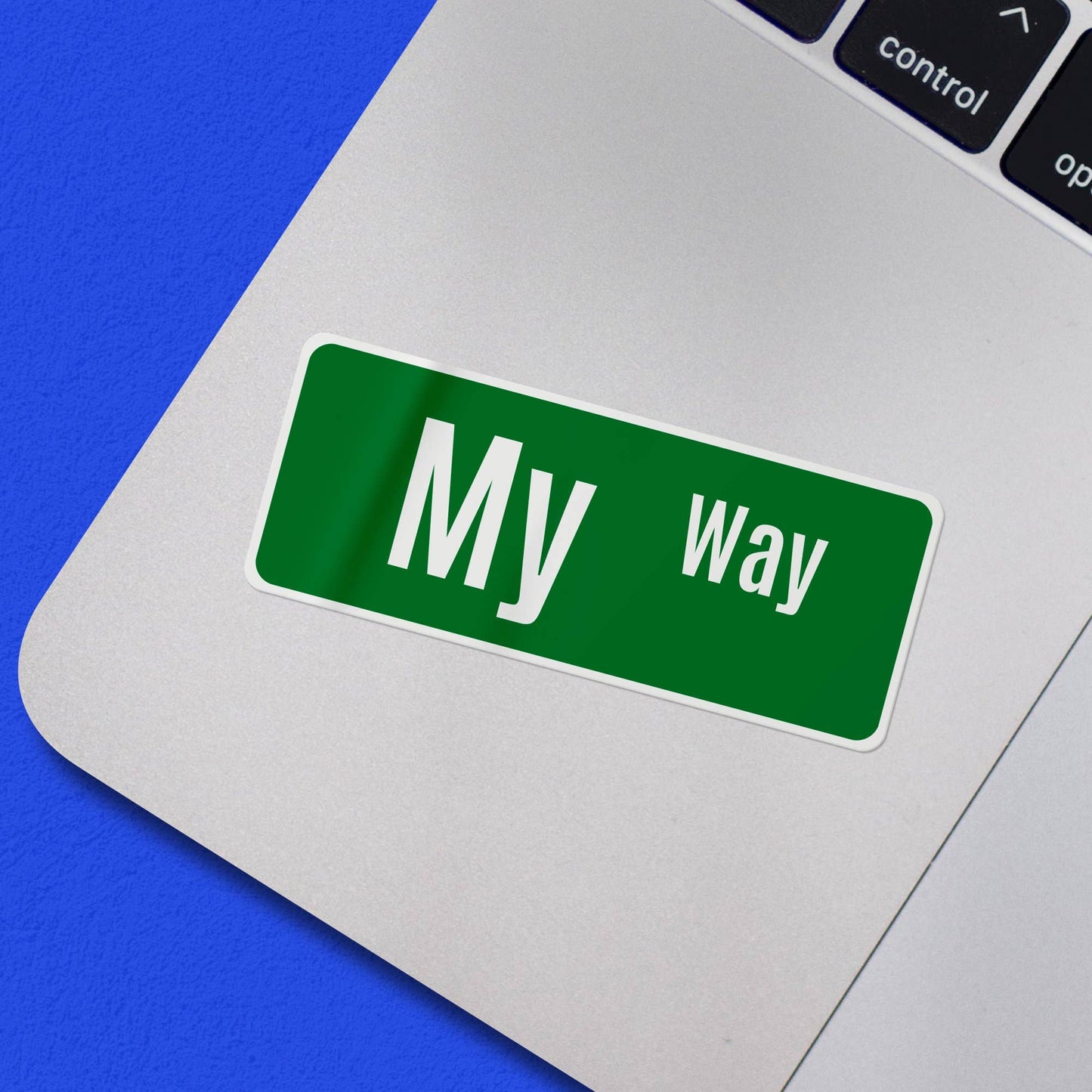 Green My Way sticker on a laptop keyboard.