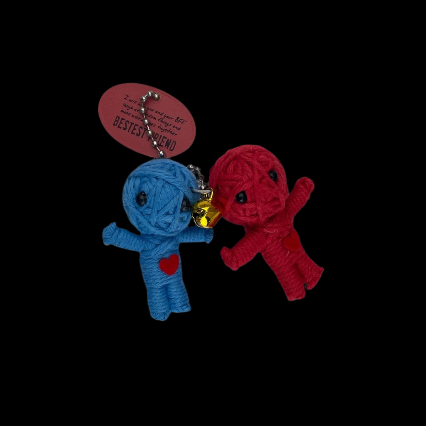 Blue and red yarn-wrapped dolls with heart patches, hanging from a tag.