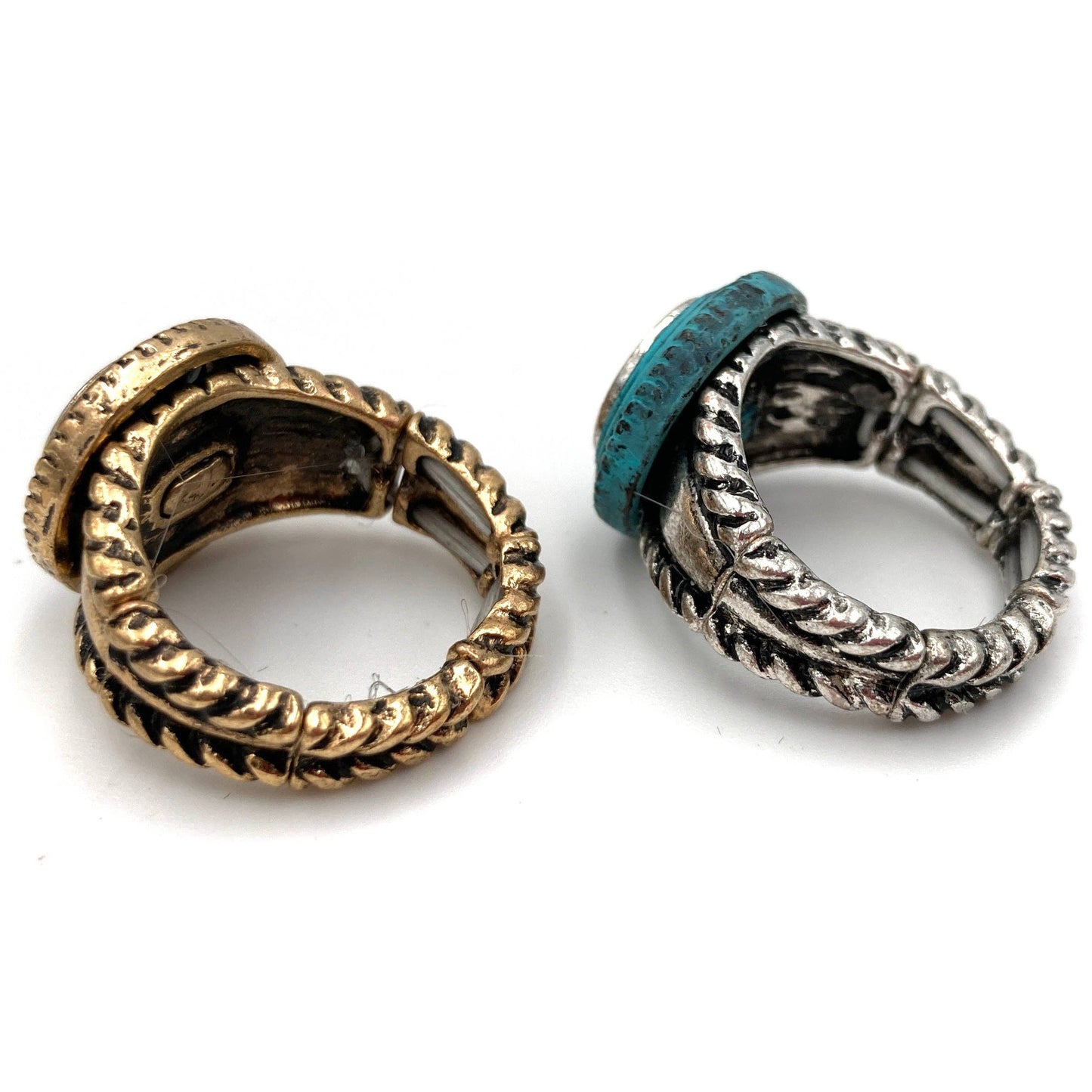Two intricately designed rings, one gold and one silver with turquoise accent.