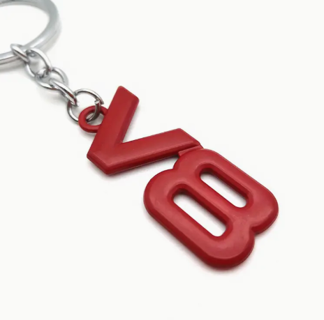 Red V8 keychain with metallic ring and chain.
