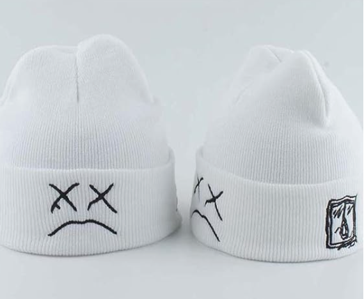 White beanie hats with black sad face and abstract logo design.