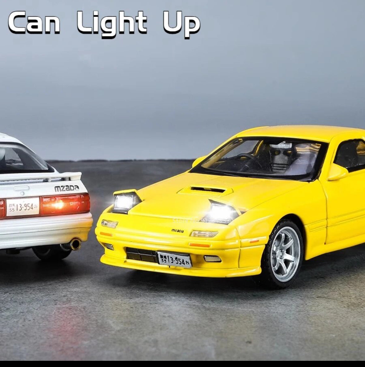 Yellow and white toy cars with headlights on, displayed side by side.