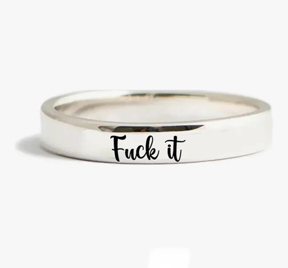 Silver ring with Fuck it engraved in cursive script.