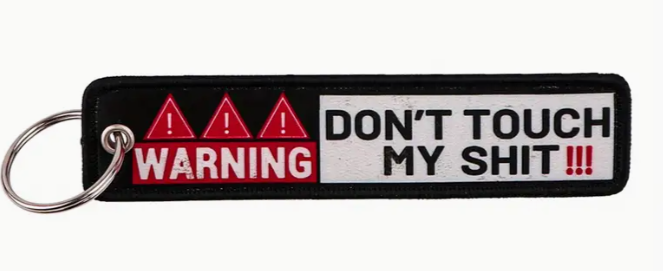 Keychain with WARNING DONT TOUCH MY SHIT text and hazard symbols.