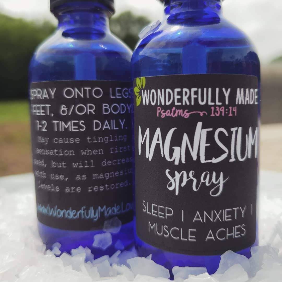 Blue glass bottles labeled Magnesium Spray for sleep, anxiety, and muscle aches.