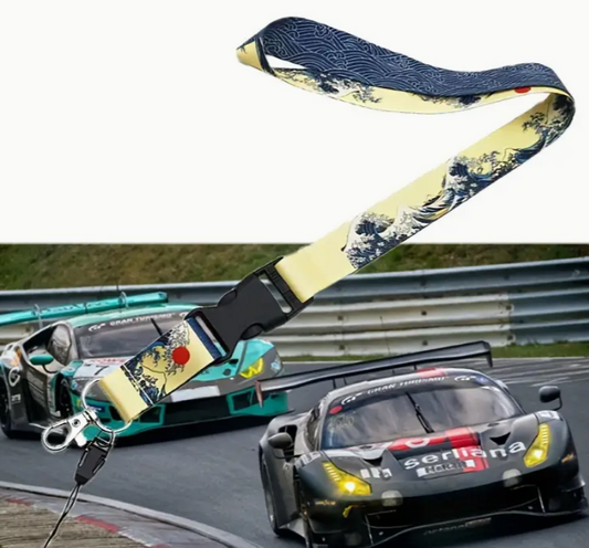 Vintage-inspired lanyard with Japanese wave design, racing cars in background.
