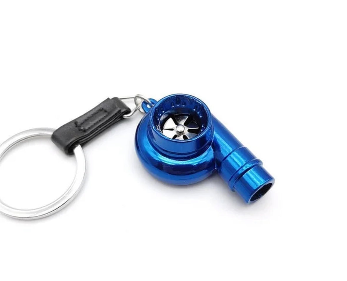 Blue turbocharger keychain with metallic finish and black clip.
