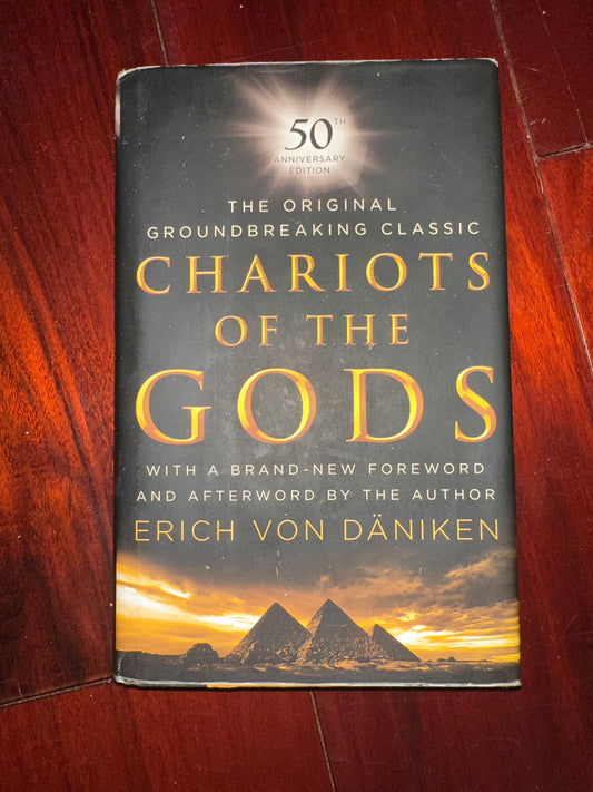 Book cover of Chariots of the Gods by Erich von Dniken, featuring pyramids and a sunset.