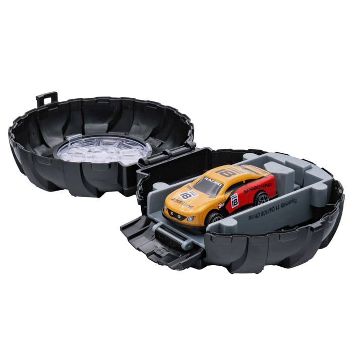 Yellow and red toy car in a black track set with clear water feature.