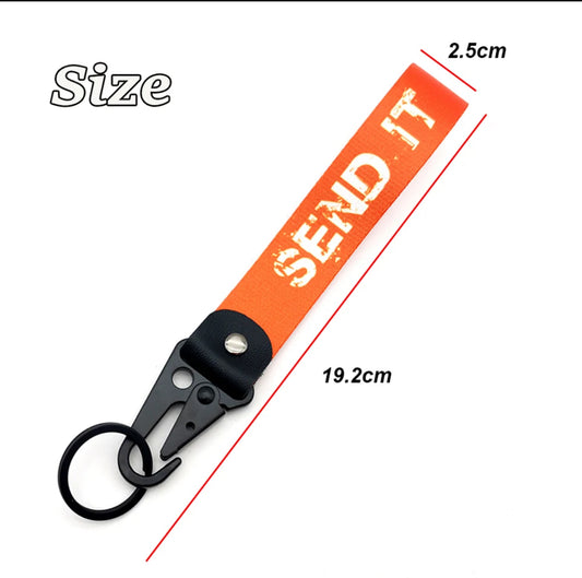 Orange SEND IT keychain with black clip and ring, 2.5cm x 19.2cm.