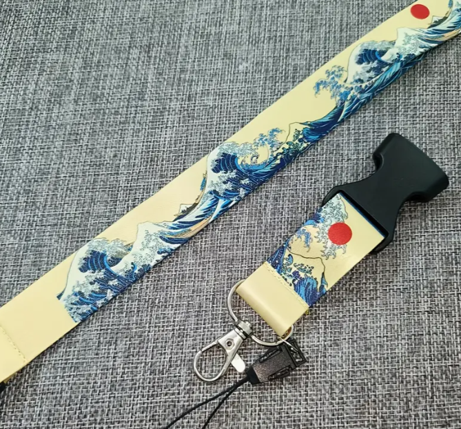 Yellow lanyard with Japanese wave design and red accents.