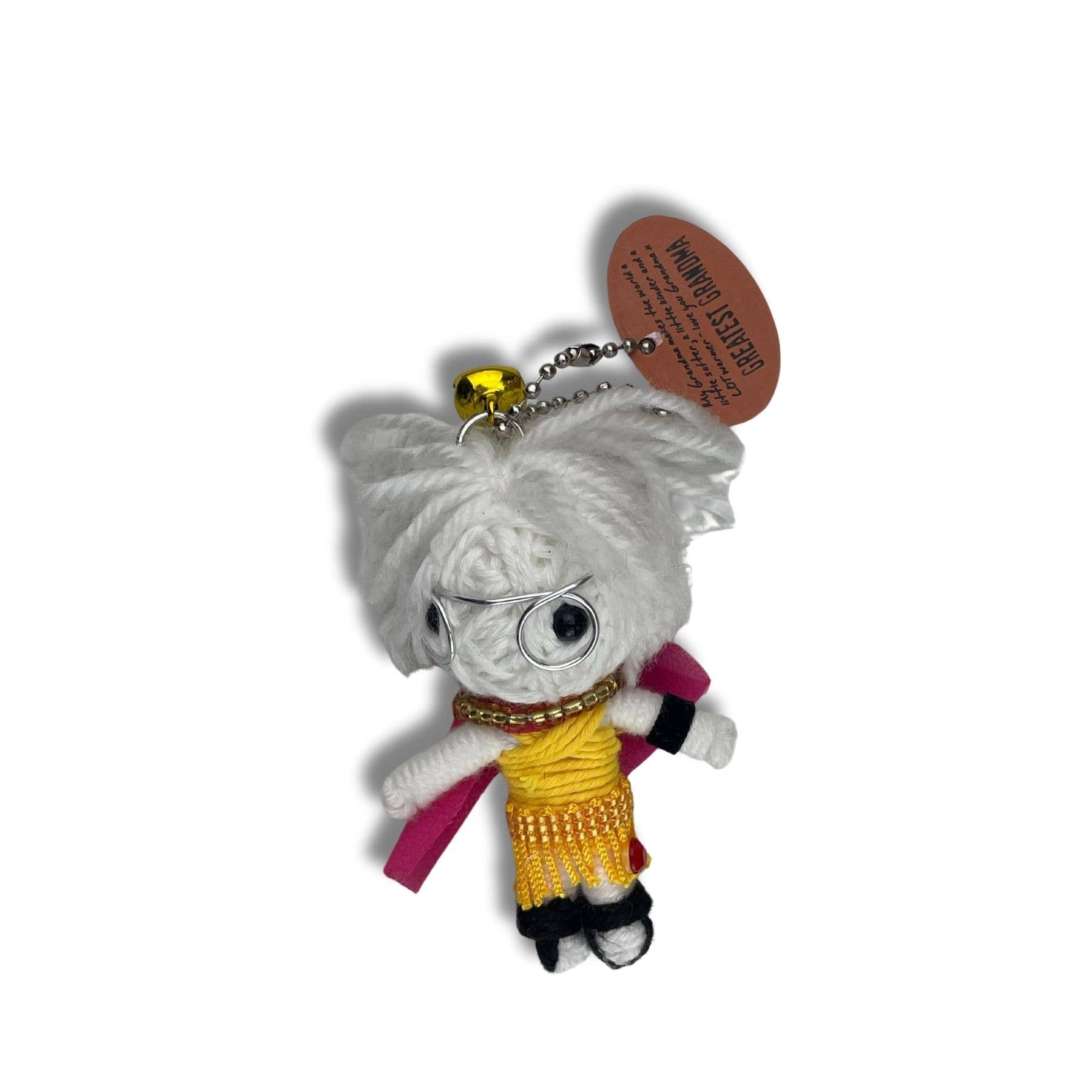 White yarn stuffed doll with glasses, yellow top, pink scarf, and tag reading Greatest Grandma keychain.