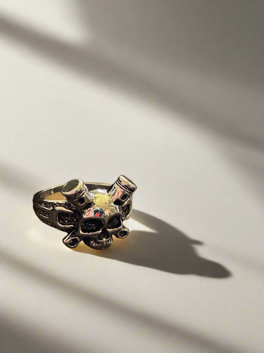 Silver skull ring with bottles, gothic design.