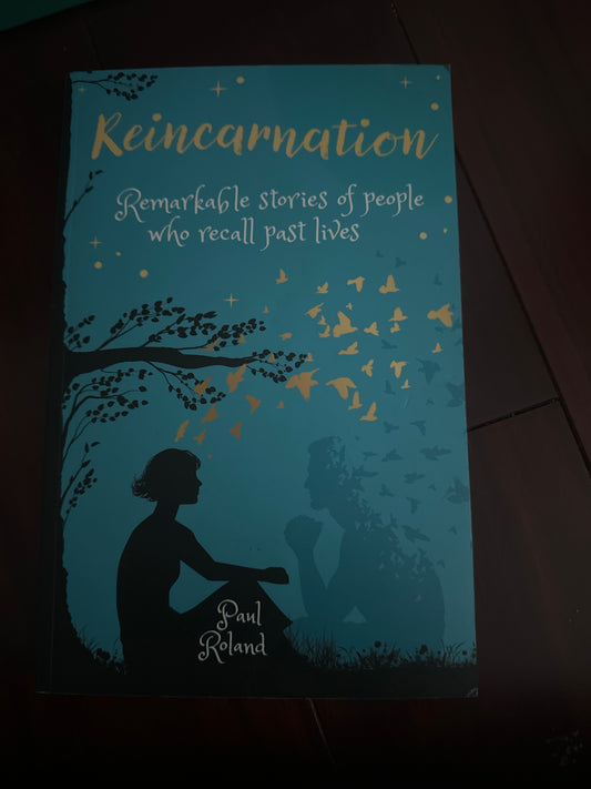 Book cover for Reincarnation by Paul Roland, featuring silhouettes and birds.
