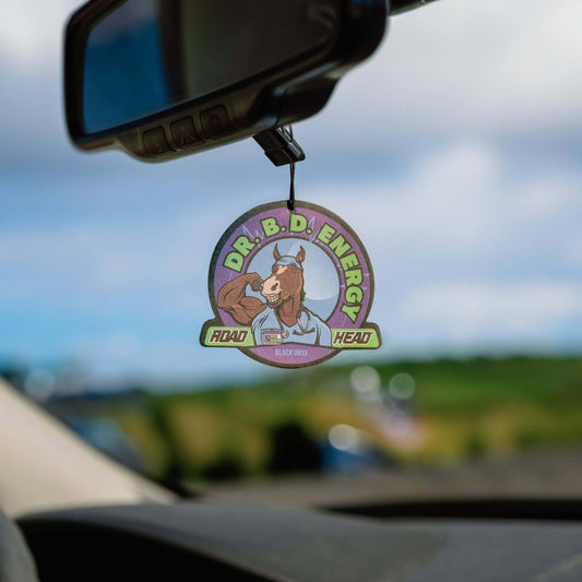 Car air freshener with Dr. B.D. Energy logo hanging from rearview mirror.