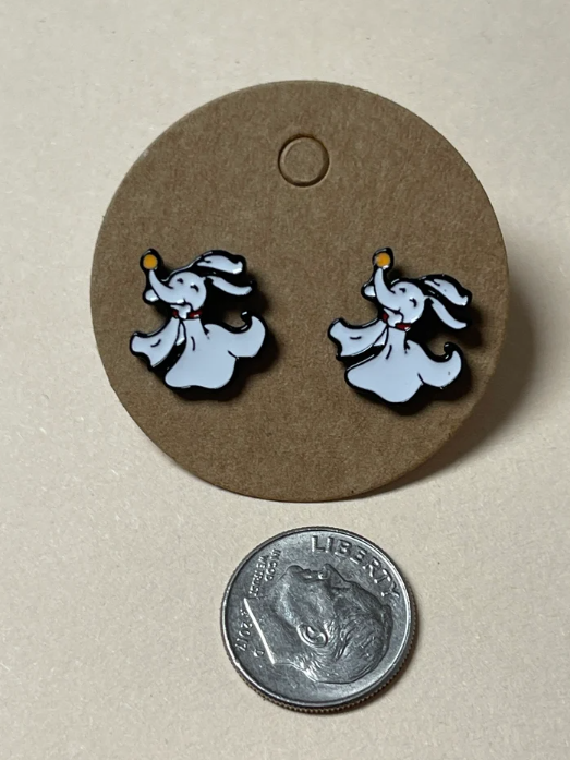 Ghostly elephant earrings on a circular display with a quarter for scale.
