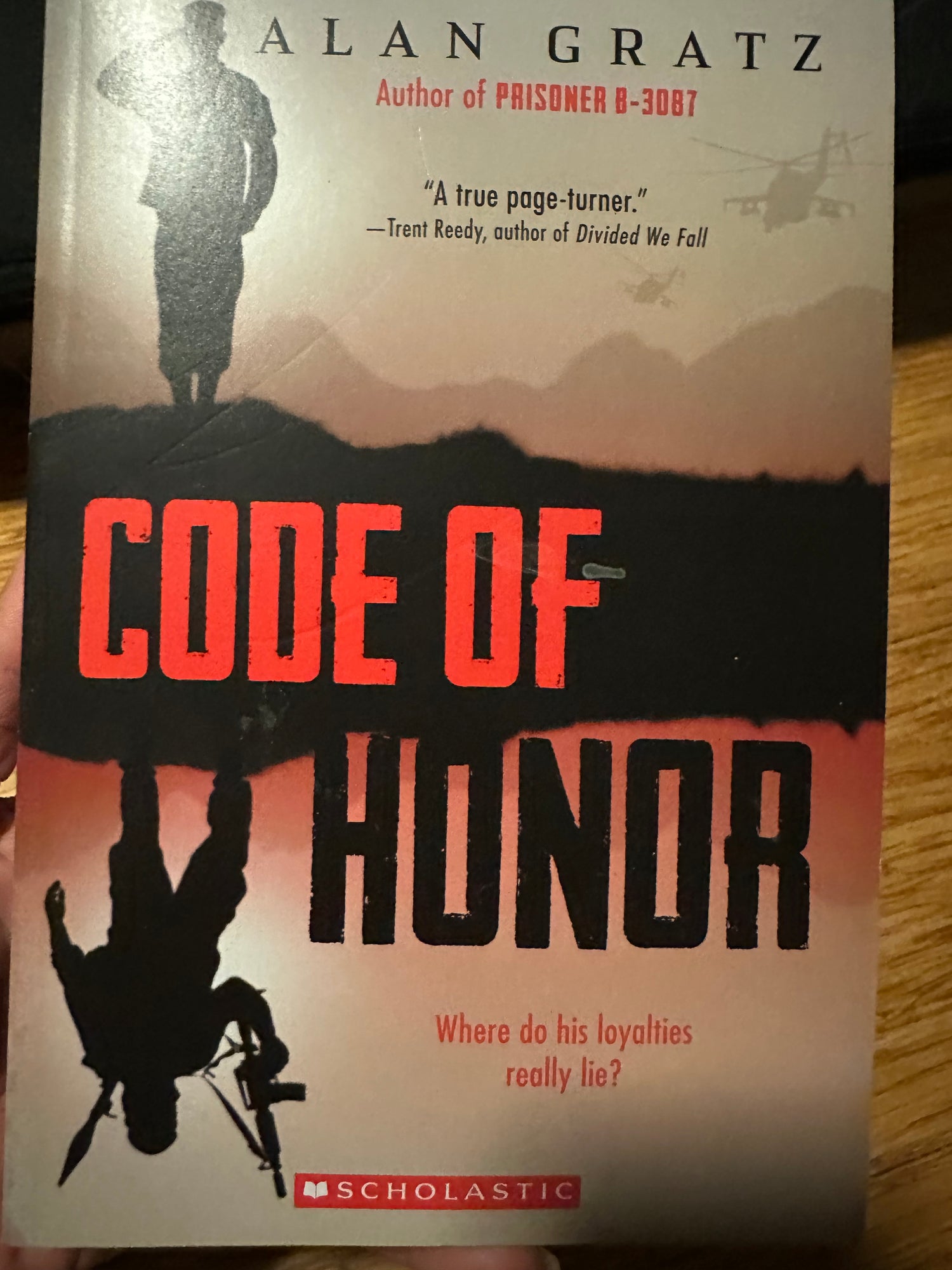 Book cover for Code of Honor by Alan Gratz, featuring silhouettes and military helicopters.