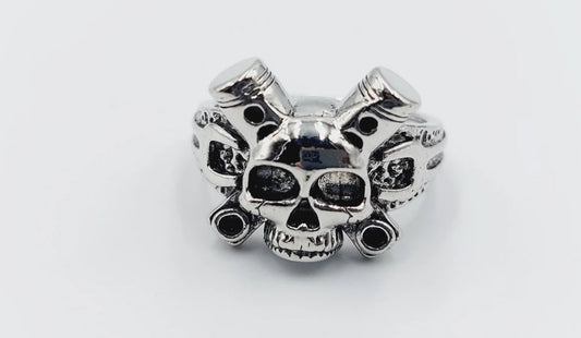Silver skull ring with crossed bones design.