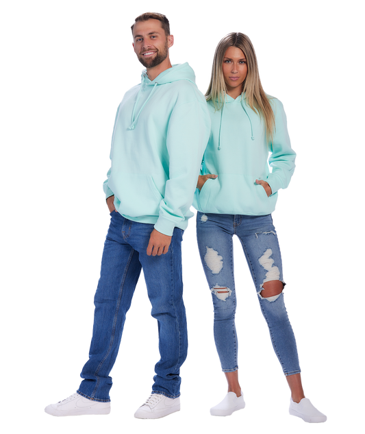 Couple wearing mint green hoodies and jeans, standing back-to-back.