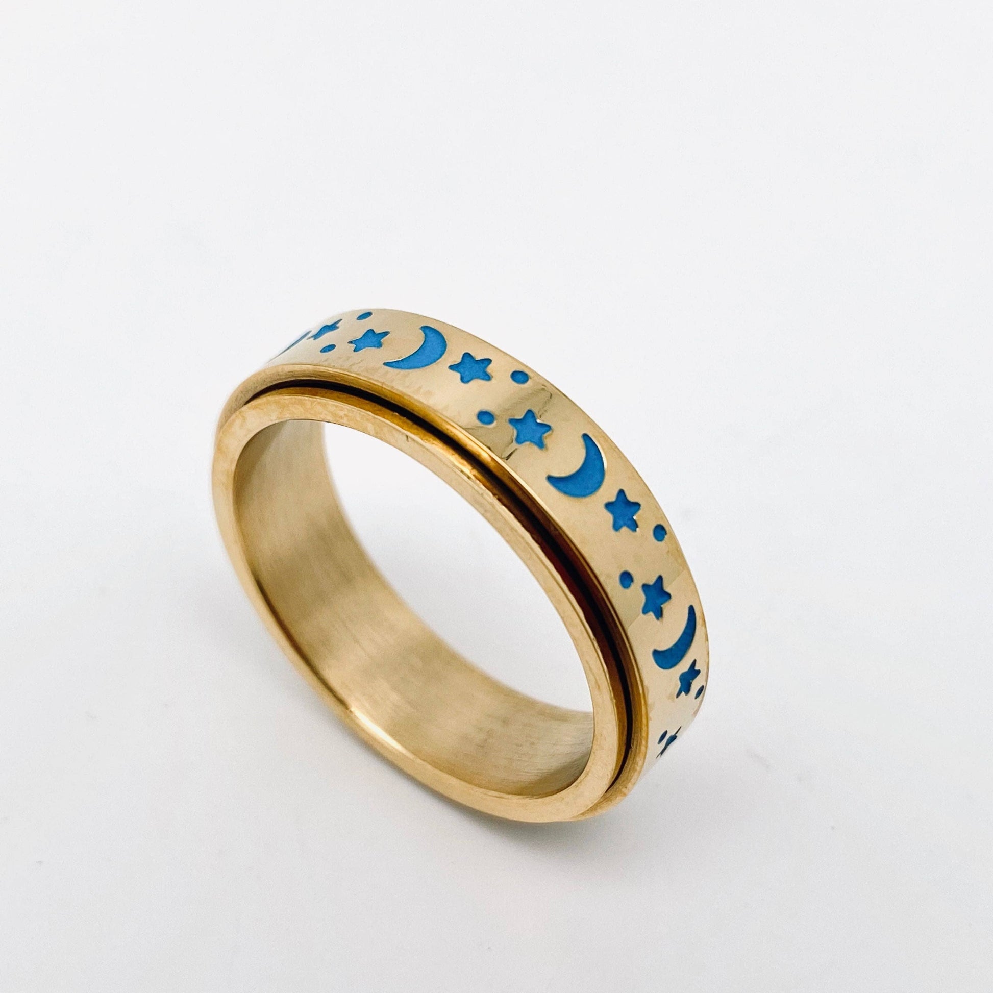 Gold spinner ring with blue moon and star designs.