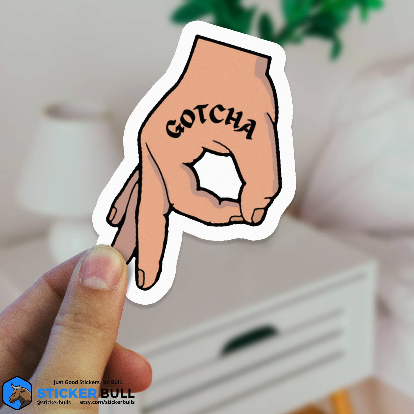 Hand gesture Gotcha sticker with cartoon hand pointing.