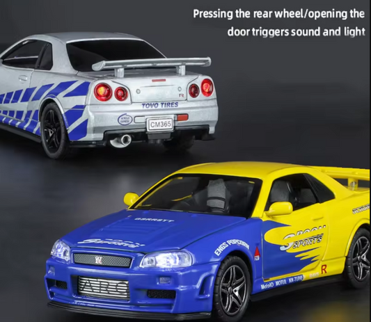 Two detailed die-cast car models, one silver and blue, the other yellow and blue.