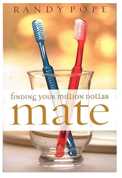 Two toothbrushes in a glass on book cover titled Finding Your Million Dollar Mate by Randy Pope.
